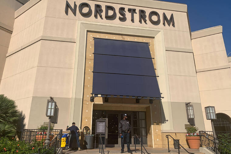ASSOCIATED PRESS
                                A security guard stands outside the Nordstrom store at The Grove retail and entertainment complex in Los Angeles. Los Angeles police say a group of thieves smashed windows at the department store at the luxury mall late Monday, the latest incident in a trend of smash-and-grab crimes is part of a national trend.