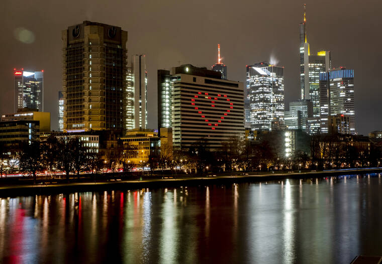 ASSOCIATED PRESS
                                A hotel has switched on the lights in some rooms to form a heart near the buildings of the banking district in in Frankfurt, Germany, on Dec. 10.