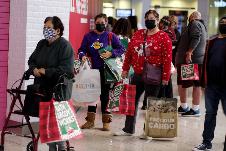 ASSOCIATED PRESS
                                Black Friday shoppers wearing face masks waited in line to enter a store at the Glendale Galleria in Glendale, Calif., in November 2020. Retailers are expected to usher in the unofficial start to the holiday shopping season, today, with bigger crowds than last year in a closer step toward normalcy. But the fallout from the pandemic continues to weigh on businesses and shoppers’ minds.