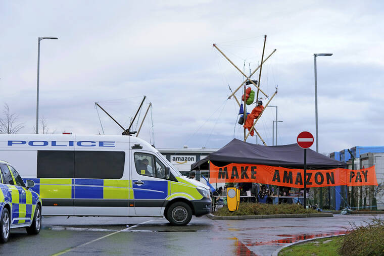 JOE GIDDENS/PA VIA AP
                                Activists from Extinction Rebellion block the entrance to the Amazon fulfilment centre preventing lorries from entering or leaving on Black Friday, the global retail giant’s busiest day of the year, in Coventry, England. The group has targeted Amazon sites in Doncaster, Darlington, Dunfremline, Newcastle, Manchester, Peterborough, Derby, Coventry, Rugeley, Dartford, Bristol, Tilbury and Milton Keynes.
