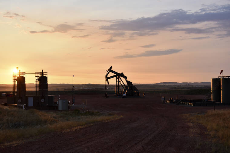ASSOCIATED PRESS
                                An oil well works at sunrise on Aug. 25 in Watford City, N.D.