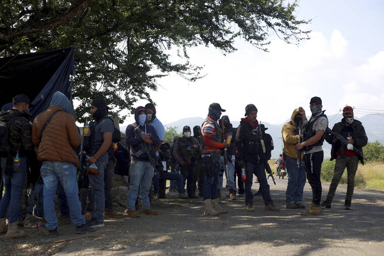 ASSOCIATED PRESS
                                Members of the so-called self-defense group known as United Towns or Pueblos Unidos, gather for a rally in Nuevo Urecho, in the Mexican western state of Michoacan. Extortion of avocado growers in western Mexico has gotten so bad that 500 vigilantes from the “self-defense” group gathered Saturday and pledged to aid police.