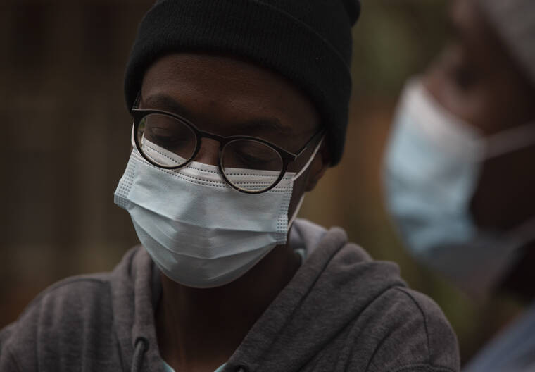 ASSOCIATED PRESS
                                A student from the Tshwane University of Technology wears a face mask outside his residence in Pretoria, South Africa on Saturday.