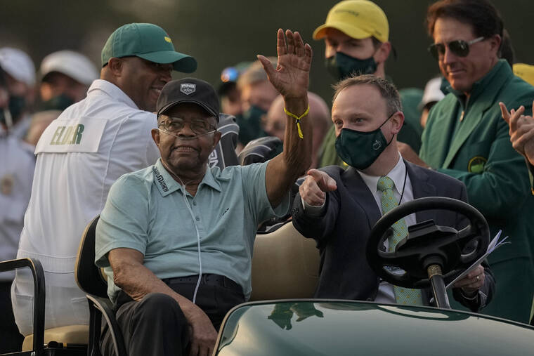 ASSOCIATED PRESS
                                Lee Elder waved as he arrived for the ceremonial tee shots before the first round of the Masters golf tournament, April 8, in Augusta, Ga. At far right is Phil Mickelson. Elder broke down racial barriers as the first Black golfer to play in the Masters and paved the way for Tiger Woods and others to follow.