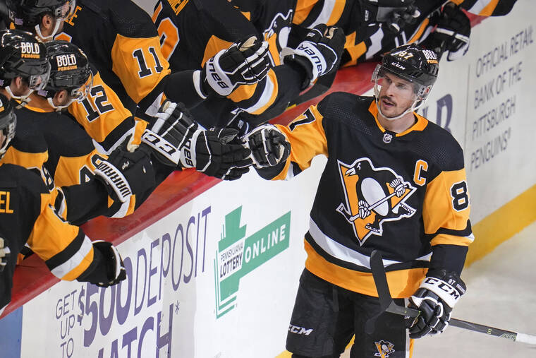 ASSOCIATED PRESS
                                Pittsburgh Penguins’ Sidney Crosby returned to the bench after scoring during the third period of an NHL hockey game against the Montreal Canadiens in Pittsburgh, Saturday.