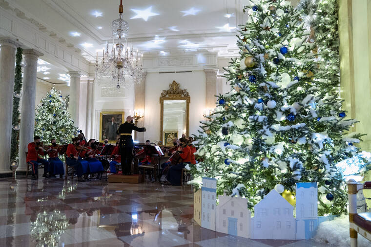 ASSOCIATED PRESS
                                A Marine band plays Christmas music in the Grand Foyer of the White House during a press preview of the White House holiday decorations in Washington.