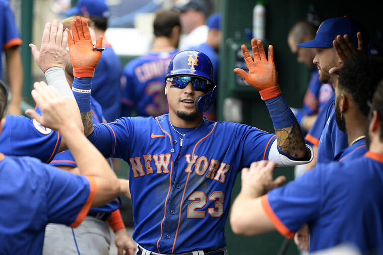 ASSOCIATED PRESS
                                The New York Mets’ Javier Baez celebrates his home run in the dugout on Sept. 5.