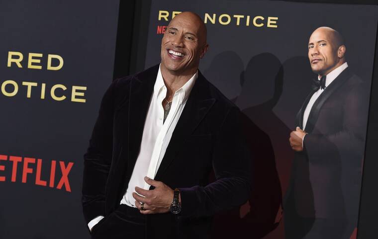 JORDAN STRAUSS/INVISION/AP
                                Cast member Dwayne Johnson arrived at the Los Angeles premiere of “Red Notice” at L.A. Live on Wednesday.