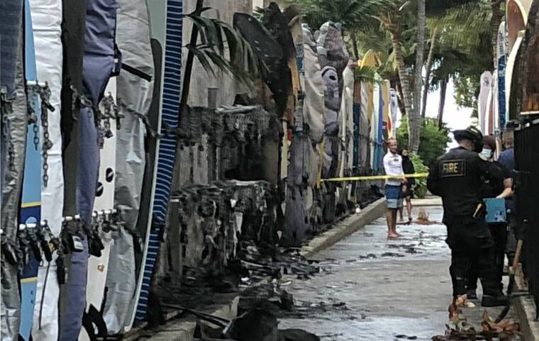 CRAIG T. KOJIMA / CKOJIMA@STARADVERTISER.COM
                                Police investigated the scene of a surf rack fire this morning at the beach access between Outrigger Waikiki and Royal Hawaiian Shopping Center.