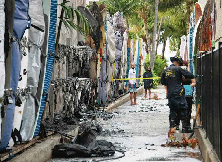 CRAIG T. KOJIMA / CKOJIMA@STARADVERTISER.COM 
                                The Honolulu Fire Department investigated another surfboard rack fire Thursday in Waikiki. It was the second rack fire in three weeks.