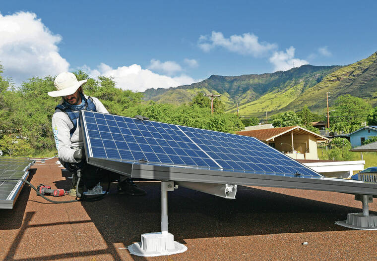 STAR-ADVERTISER / 2019
                                SunRun Inc. lead installer Marco Bernardi places one of 33 solar panels on the roof of a Waianae home.