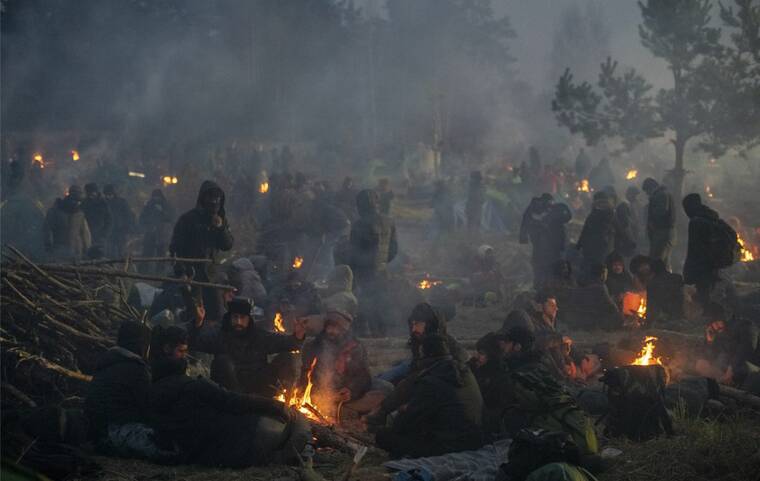 JAMES HILL/THE NEW YORK TIMES
                                Migrants gathered around fires as they camp for the night on the border with Poland in Belarus, today. The tense standoff on the border between Poland and Belarus descended into a dangerous melee this morning when Polish border guards used water cannons and tear gas to repel what they said was an attempt by migrants to breach the heavily guarded frontier.