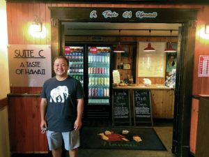 Honolulu resident Kirk Nakamoto discovered A Taste of Hawaii restaurant in Pocatello, Idaho, in August. The owners, who are originally from Hawaii, are pictured on the mat behind him. Photo by Helen Nakamoto.