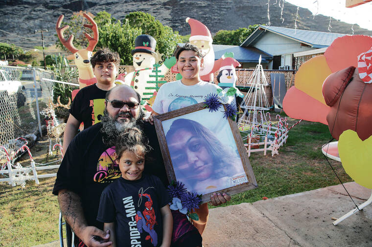 JAMM AQUINO / JAQUINO@STARADVERTISER.COM
                                Roy French, middle, has been struggling since his wife, Melissa Santos, died four years ago. This year his right leg had to be amputated because of an infection and he was unable to return to work. He and his children, clockwise from top left, Chase, 12, Erin, 16, and Matthias, 6, had to move in with family and are living on his disability income. He especially wants some clothes, video games for the kids and hula classes for his daughter. Erin holds a photo of Santos.