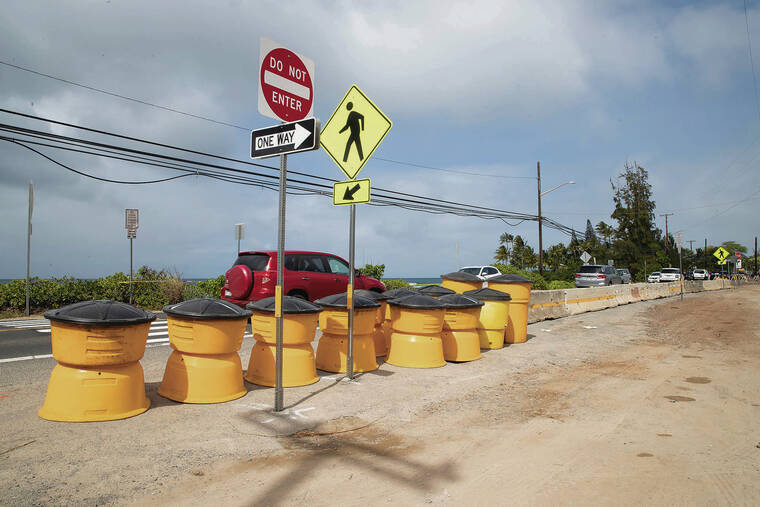 CINDY ELLEN RUSSELL / CRUSSELL@STARADVERTISER.COM
                                Vehicles drive past concrete barriers, plastic barrels and two new crosswalks installed along Kamehameha Highway across Laniakea. Work will continue at the site, with a single-lane closure on the highway from 8:30 a.m. to 2 p.m. Monday through Friday.