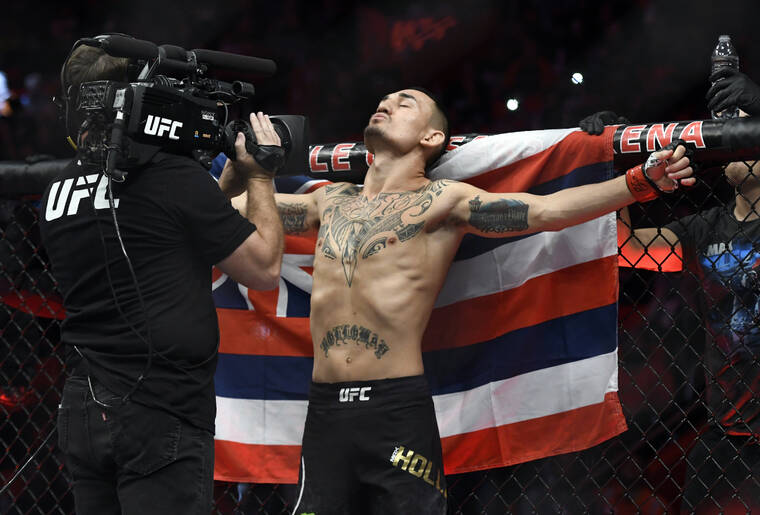 ASSOCIATED PRESS / 2017
                                Max Holloway, standing in front of the state flag of Hawaii, prepared to fight Jose Aldo of Brazil during a UFC 218 featherweight mixed martial arts bout in Detroit.