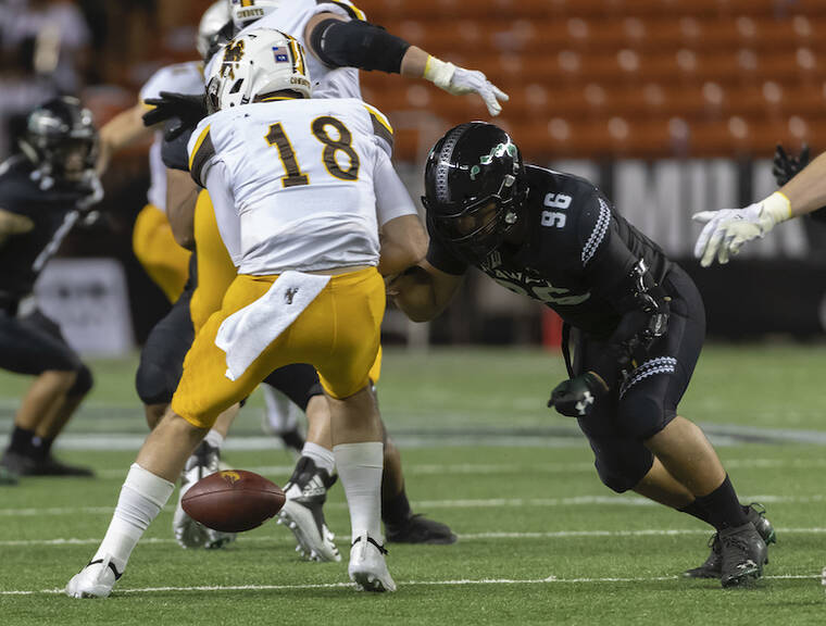 ASSOCIATED PRESS / OCTOBER 2018
                                Hawaii defensive lineman Kaimana Padello (96) strips the football away from Wyoming quarterback Tyler Vander Waal (18) in the first half of an NCAA college football game. Today Hawaii faces Wyoming at the War Memorial Stadium.