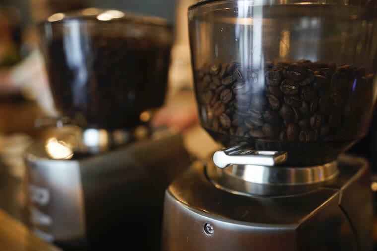 ASSOCIATED PRESS / SEPT. 1
                                Coffee beans are seen in grinders at Vigilante Coffee 2021, in College Park, Md.