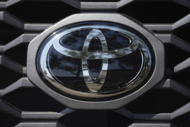 ASSOCIATED PRESS
                                The company logo shines off the grille of a Toyota.