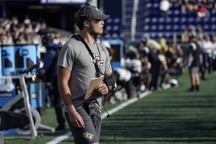 ASSOCIATED PRESS / OCTOBER 2
                                UCF quarterback Dillon Gabriel wears a sling while watching the first half of an NCAA college football game against Navy from the sidelines in Annapolis, Md.