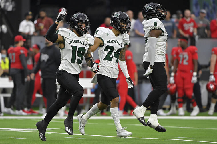 ASSOCIATED PRESS
                                Hawaii defensive back Quentin Frazier and defensive back Kai Kaneshiro celebrate after Hawaii made an interception against UNLV during the first half.