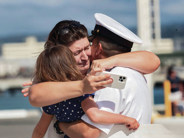 CINDY ELLEN RUSSELL / CRUSSELL@STARADVERTISER.COM
                                Ashley Gaona embraced her husband Chief Petty Officer Randy Gaona and their daughter Everly on Thursday. The couple had been apart for a total of 669 days.