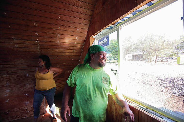 JAMM AQUINO / JAQUINO@STARADVERTISER.COM
                                Above, Puuhonua o Waianae resident Sara Baird, left, and James Pakele, president of Dynamic Community Solutions, stand inside the new house at the mauka village in Waianae Valley.