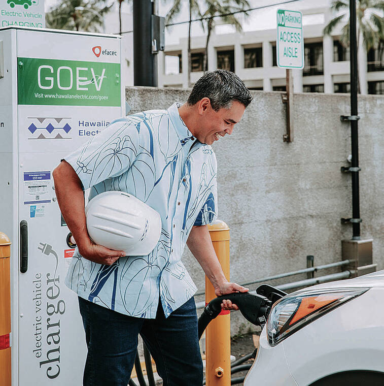 COURTESY HAWAIIAN ELECTRIC
                                Hawaiian Electric employee Blaine Cacho charges a company EV at one of the two DC fast-charging stations at Hawaiian Electric’s Ward Avenue location.
