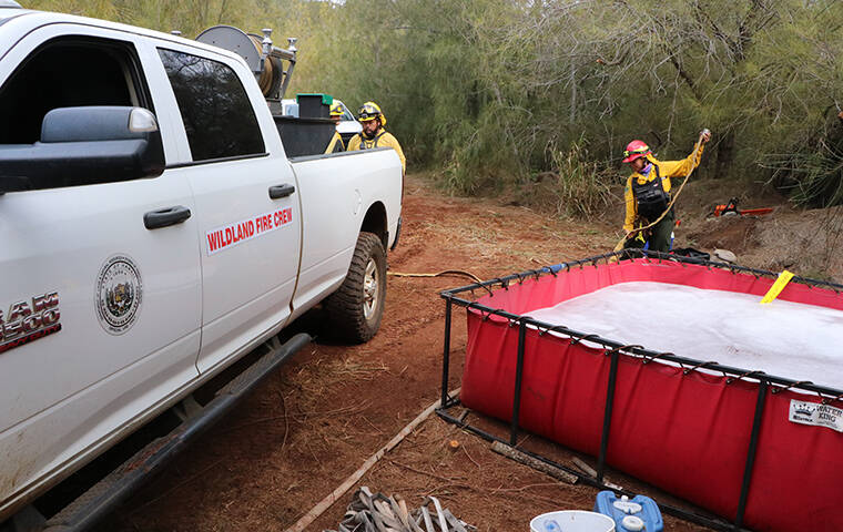 COURTESY DLNR
                                Department of Land and Natural Resources Division of Forestry and Wildlife crews set up portable water tanks where a contract helicopter and one from the Honolulu Fire Department could refill for water drops on hot spots.
