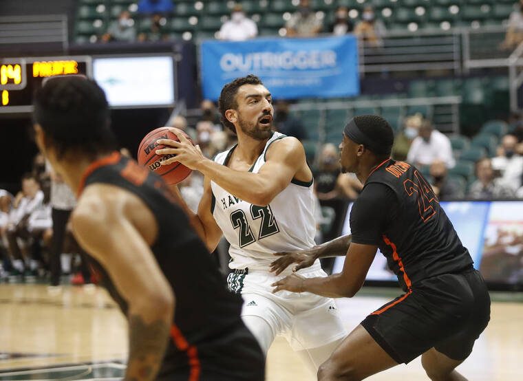 CINDY ELLEN RUSSELL / CRUSSELL@STARADVERTISER.COM
                                Hawaii forward Jerome Desrosiers looks to pass the ball as Pacific guard Greg Outlaw defends in the first half.