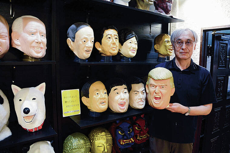 JAPAN NEWS-YOMIURI
                                Ogawa Studios Co. President Nao Tanaka holds a mask of former U.S. President Donald Trump in Saitama City.