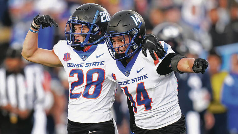 ASSOCIATED PRESS
                                Boise State’s Kekaula Kaniho, left, pointed to younger brother Kaonohi after Kaonohi’s interception against BYU in Provo, Utah, on Oct. 9.