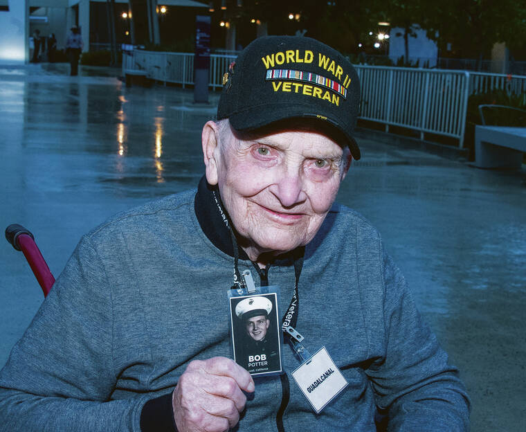 CRAIG T. KOJIMA/CKOJIMA@STARADVERTISER.COM
                                Robert Potter, WWII Guadacanal veteran with a photo of himself as a marine.