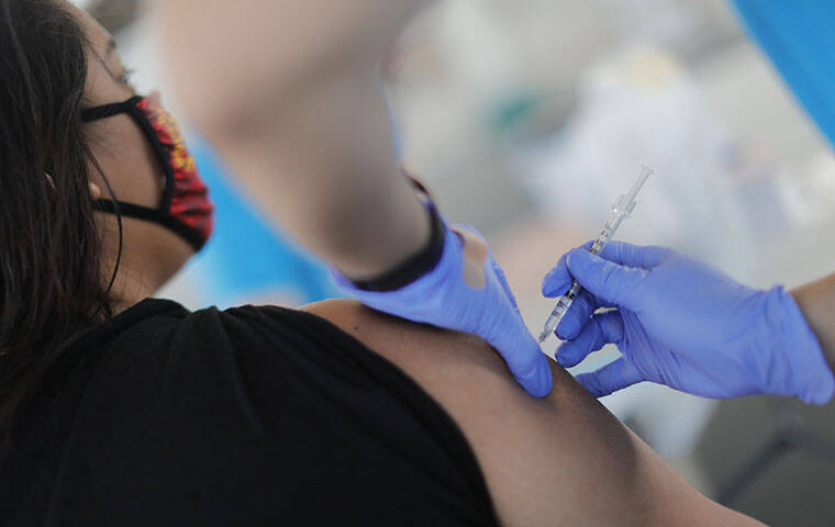 JAMM AQUINO / JAQUINO@STARADVERTISER.COM
                                A Pfizer-BioNTech COVID-19 vaccine was administered, May 11, during a vaccination clinic at Papakolea Community Center.