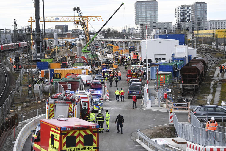 SVEN HOPPE/DPA VIA ASSOCIATED PRESS
                                Firefighters, police officers and railway employees stood on a railway site in Munich, Germany, today. Police in Germany said four people have been injured including seriously in an explosion at a construction site next to a busy railway line in Munich.
