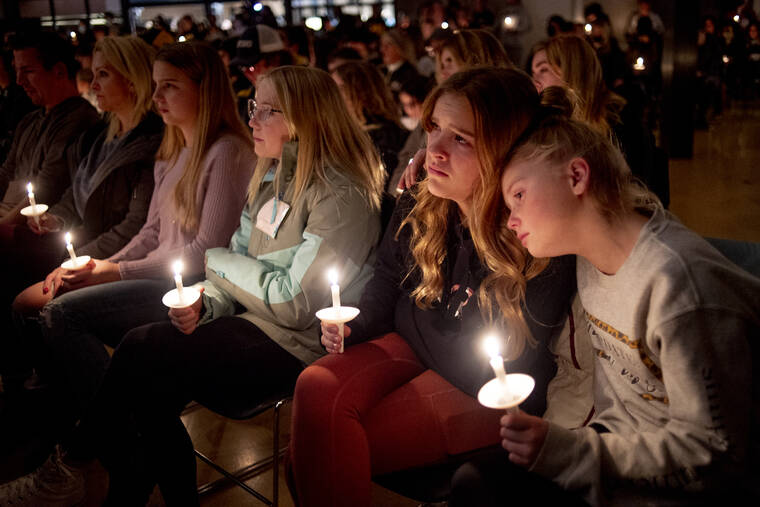 JAKE MAY/THE FLINT JOURNAL VIA ASSOCIATED PRESS
                                Emerson Miller, right, leaned on her friend Joselyn’s shoulder as they listened to Jessi Holt, pastor at LakePoint Community Church, during a prayer vigil at the church after the Oxford High School school shooting, Tuesday, in Oxford, Mich.