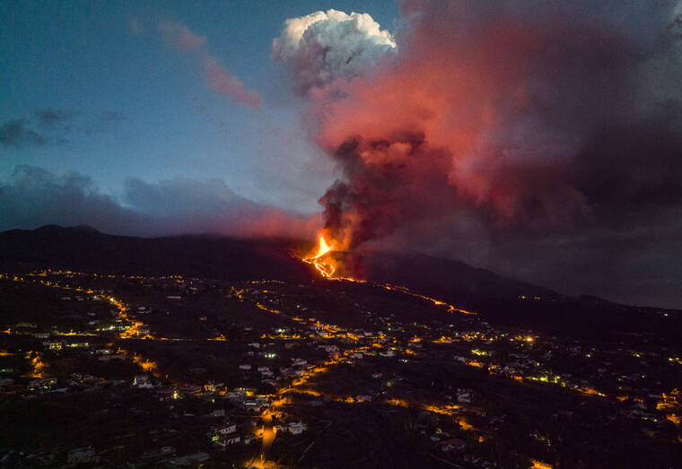 ASSOCIATED PRESS|
                                Smoke rose from a volcano on the Canary island of La Palma, Spain, Tuesday. Several new volcanic vents opened in La Palma, releasing new lava that flowed fast down a ridge and threatened to widen the impact on evacuated land, infrastructure and homes.