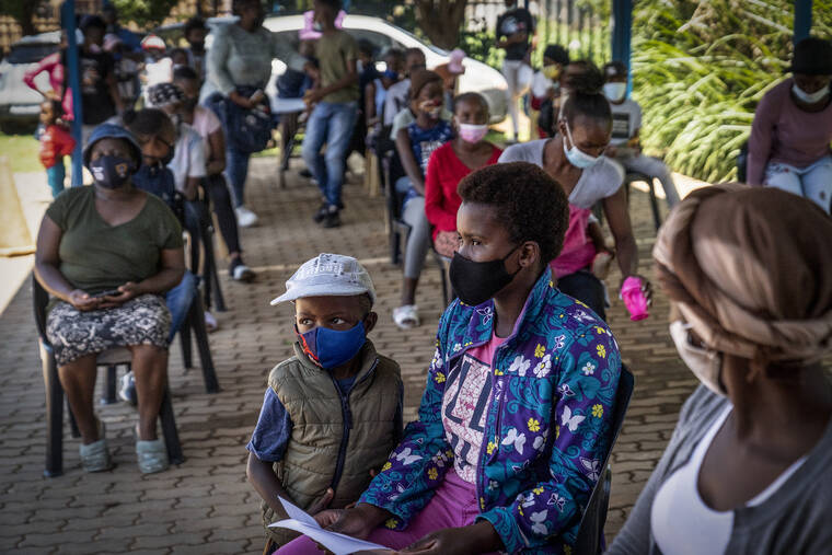ASSOCIATED PRESS
                                People lined up to be vaccinated against COVID-19 in Lawley, south of Johannesburg, South Africa, today. South African doctors say the rapid increase in COVID-19 cases attributed to the new omicron variant is resulting in mostly mild symptoms.