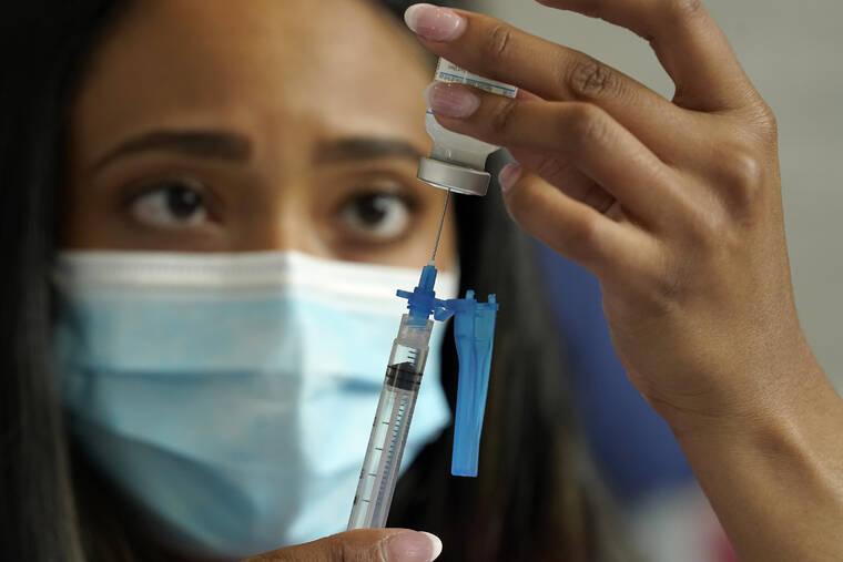 ASSOCIATED PRESS
                                Licensed practical nurse Yokasta Castro, of Warwick, R.I., draws a Moderna COVID-19 vaccine into a syringe at a mass vaccination clinic in May at Gillette Stadium in Foxborough, Mass.