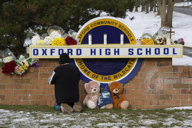 ASSOCIATED PRESS
                                A well wisher kneels to pray at a memorial on the sign of Oxford High School in Oxford, Mich., on Wednesday. A 15-year-old sophomore opened fire at the school, killing several students and wounding multiple other people, including a teacher.