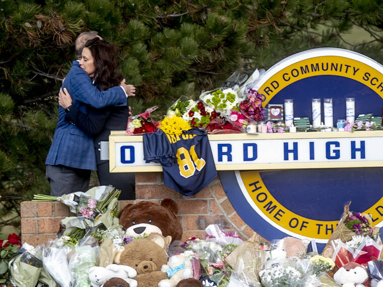 JAKE MAY/THE FLINT JOURNAL VIA ASSOCIATED PRESS
                                Gov. Gretchen Whitmer embraced Oakland County Executive Dave Coulter as the two left flowers and paid their respects, Thursday morning, at Oxford High School in Oxford, Mich. A prosecutor in Michigan filed involuntary manslaughter charges today against the parents of a boy who is accused of killing four students at Oxford High School, after saying earlier that their actions went “far beyond negligence.”