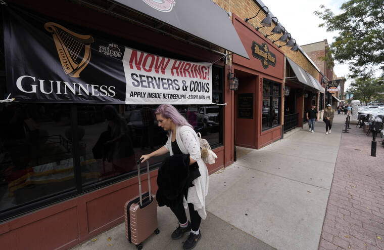 ASSOCIATED PRESS
                                A traveler wheeled her baggage past a now hiring sign outside a bar and restaurant, Oct. 9, in Sioux Falls, S.D. America’s employers slowed the pace of their hiring in November, adding 210,000 jobs, the lowest monthly gain in nearly a year.