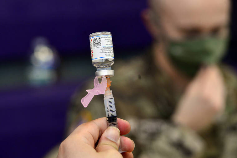 ASSOCIATED PRESS
                                Spc. Brady McNeil, a radiologist with the Vermont Army National Guard, draws up a dose of the Moderna COVID-19 during a vaccination clinic at the Brattleboro Area Middle School on April 14 in Brattleboro, Vt. More than 11,000 members of the Air National Guard and Reserve did not meet the Thursday deadline to get the COVID-19 vaccine, and could begin to face consequences if they don’t get the mandated shots or receive an exemption.