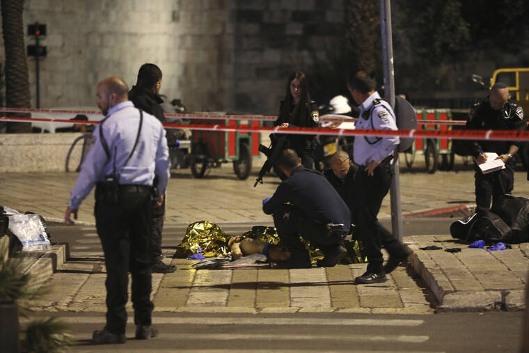 ASSOCIATED PRESS
                                Israeli police examine the body of a man shot near Damascus Gate to the Old City of Jerusalem. Israeli police shot a Palestinian on Saturday after an ultra-Orthodox Jewish man was stabbed and wounded near Damascus Gate in Jerusalem’s Old City, a crowded area that is often the scene of demonstrations and clashes.