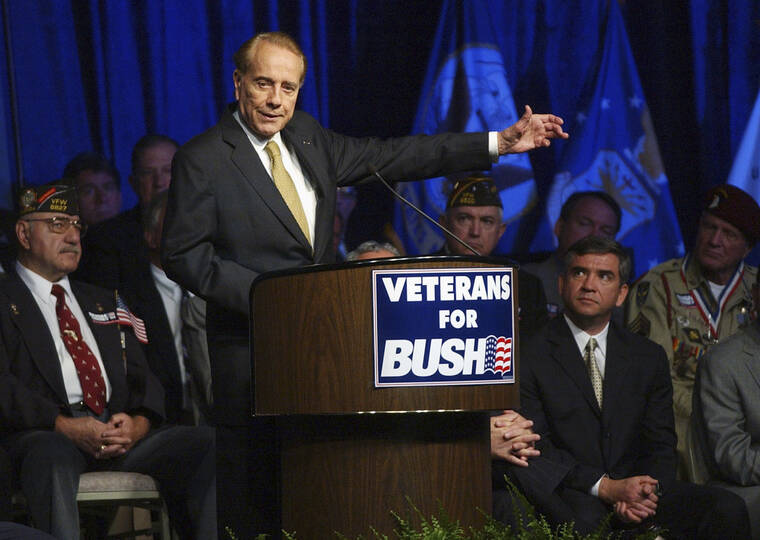 ASSOCIATED PRESS
                                Former U.S. Sen. Bob Dole, surrounded by military veterans, gestures during a Bush-Cheney 2004 National Veterans Leadership Team rally in Tampa, Fla., in 2004. Dole, who overcame disabling war wounds to become a sharp-tongued Senate leader from Kansas, a Republican presidential candidate and then a symbol and celebrant of his dwindling generation of World War II veterans, has died. He was 98.