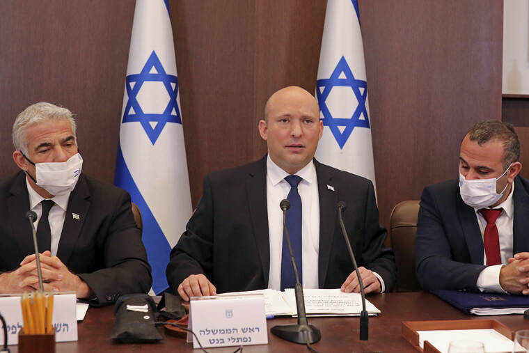 ASSOCAITED PRESS
                                Israeli Prime Minister Naftali Bennett, center, chairs a weekly cabinet meeting, at the prime minister’s office in Jerusalem today. Bennett urged world powers to take a hard line against Iran in negotiations to curb the country’s nuclear program, as his top defense and intelligence officials headed to Washington amid the flailing talks.