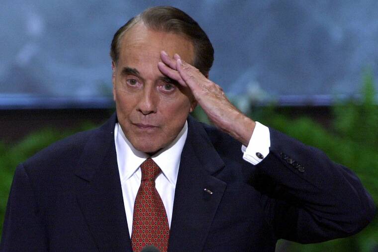 ASSOCIATED PRESS FILE
                                Former senator and former presidential candidate Bob Dole salutes after a speech at the Republican National Convention in the First Union Center in Philadelphia on Aug, 1, 2000. Dole died Sunday.