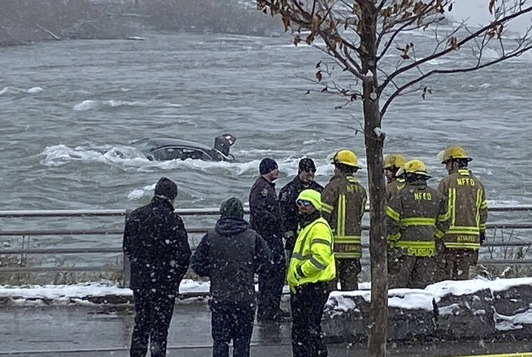 SHARON CANTILLON/BUFFALO NEWS VIA AP
                                First responders monitor a car partially submerged in the Niagara River near the brink of American Falls in Niagara Falls, N.Y. A car entered the Niagara River and became stuck in the rapids just yards from the brink of Niagara Falls on Wednesday, the fate of any occupants of the vehicle unknown. It was not immediately clear how or where the gray car entered the frigid, rushing water or whether anyone was inside.
