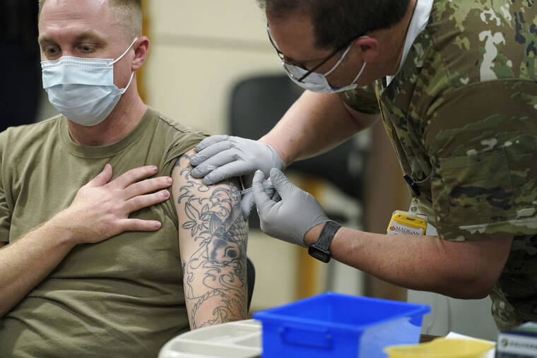 ASSOCIATED PRESS
                                Staff Sgt. Travis Snyder, left, received the first dose of the Pfizer COVID-19 vaccine given at Madigan Army Medical Center at Joint Base Lewis-McChord in Washington state, in December 2020, south of Seattle. The Army said 98% of its active-duty force had gotten at least one dose of the mandatory coronavirus vaccine as of this week’s deadline for the shots.