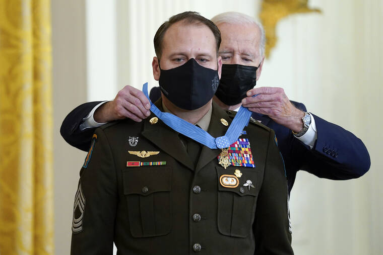 ASSOCIATED PRESS
                                President Joe Biden presents the Medal of Honor to Army Master Sgt. Earl Plumlee for his actions in Afghanistan on Aug. 28, 2013, during an event in the East Room of the White House today.
